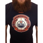 	Tričko Edmonton Oilers od značky Reebok s krátkým rukávem a logem Edmonton Oilers na hrudi.